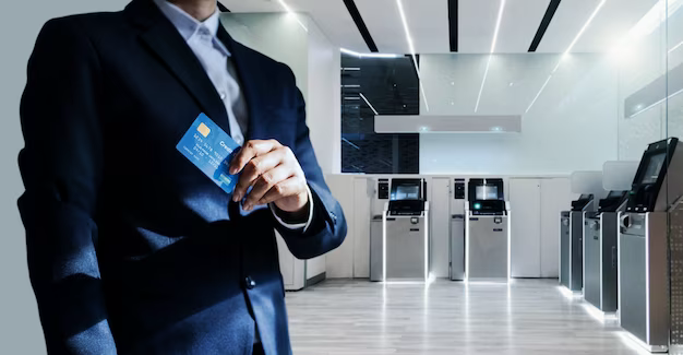 A man in a suit holds a bank card