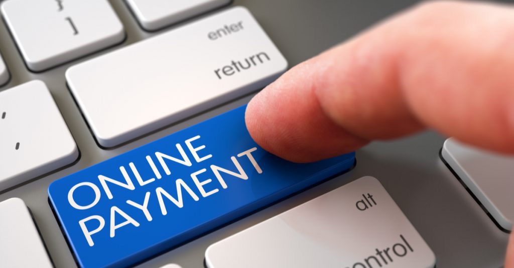 Finger presses the Online Payment button