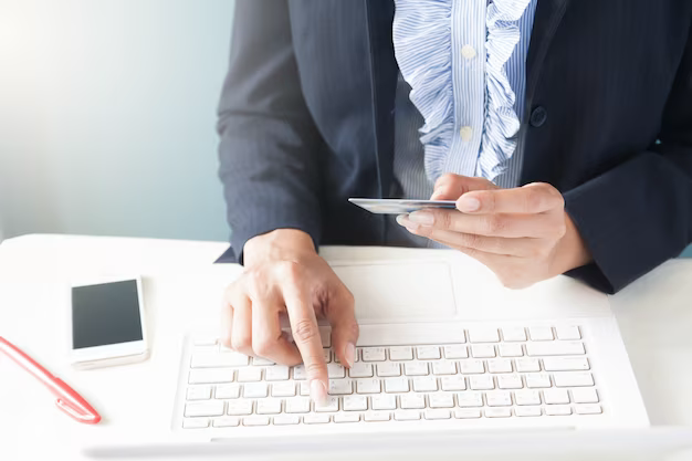 Woman in a dark suit checking credit card details