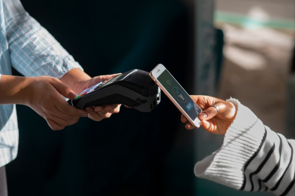 Customer making a contactless payment with a smartphone