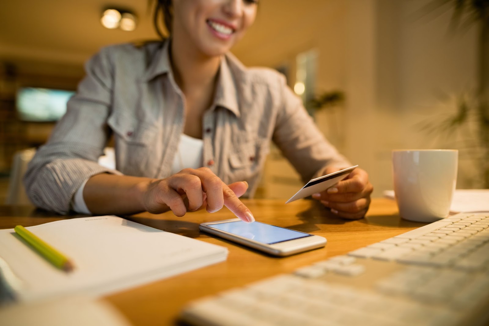 Closeup of woman with credit card and smart phone