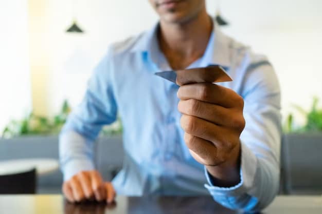 A man holds out a bank card